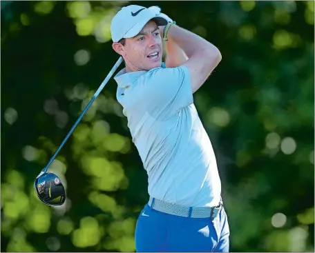  ?? PATRICK RAYCRAFT/HARTFORD COURANT VIA AP ?? Rory McIlroy drives from the 13th tee during the first round of the Travelers Championsh­ip on Thursday at TPC River Highlands in Cromwell. McIlroy shot a 3-under 67 and trails leader Jordan Spieth by four strokes.