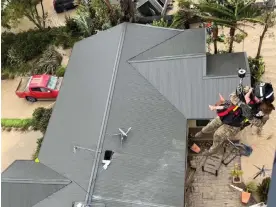  ?? Photograph: New Zealand Defence Force/AFP/ Getty Images ?? A stranded person is airlifted from their rooftop by a military helicopter in the Esk Valley near Napier in New Zealand’s North Island on Tuesday. Ex-Cyclone Gabrielle swept away roads, inundated homes and cut off regions.