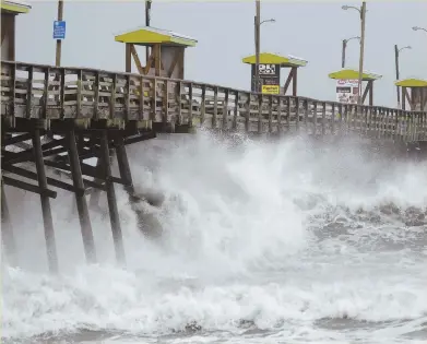  ?? AP PHOTO, ABOVE; AP FILE PHOTO, BELOW ?? WAVES OF BLAME: Surf ravages the Bogue Inlet Pier yesterday in Emerald Isle, N.C. Below, President Trump and Vice President Mike Pence tour Naples, Fla., after Hurricane Irma a year ago.