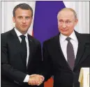  ?? Dmitri Lovetsky ?? The Associated Press French President Emmanuel Macron shakes hands with Russian President Vladimir Putin after a joint news conference Thursday.