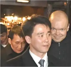  ??  ?? Choe (background left) leaves with other members of the North Korean delegation the restaurant Saaga in Central Helsinki, Finland. — AFP photo