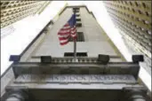  ?? RICHARD DREW — THE ASSOCIATED PRESS FILE ?? In this Friday file photo, the American flag flies above the Wall Street entrance to the New York Stock Exchange. After a promising start, U.S. stock indexes gave up an early rally and ended mostly lower Thursday after Republican­s delayed a vote on...