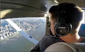  ?? AP ?? Aaron Ludomirski, an instructor for Infinity Flight Group, flies over the Hudson River in New York in 2017 as he worked to gain the required flying time to become an airline pilot.