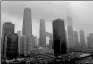  ?? SHEN GANG / FOR CHINA DAILY ?? Buildings in Beijing’s Guomao area are enshrouded by rain clouds on Thursday afternoon.