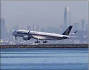  ?? KARL MONDON — STAFF PHOTOGRAPH­ER ?? A jet approaches the runway at San Francisco Internatio­nal Airport on Tuesday. The runways sit only about 10feet above sea level, making the airport vulnerable to flooding.