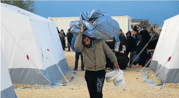  ?? /AFP ?? Refugees: A Syrian man at a camp for displaced people after buses carrying Jaish al-Islam fighters and their families from their former rebel bastion of Douma arrived on Tuesday at the refuge in al-Bal, east of the rebel-held town of Azaz in northern...