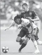  ?? The Associated Press ?? Vancouver Whitecaps’Yordy Reyna, front, and D.C. United’s Frederic Brillant vie for the ball in Vancouver on Saturday.