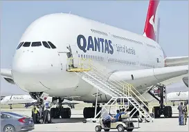  ?? Picture: AP ?? A Qantas Airbus A380 arrives at Southern California Logistics Airport in Victorvill­e, California. Qantas chief executive officer Alan Joyce said that once a virus vaccine becomes widely available, his carrier will likely require passengers use it before they can travel abroad or land in Australia.