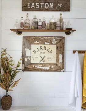  ??  ?? (below, right) These signs are crafted from vintage barnwood, and the bottles are also vintage. “I just love chippy vintage items,” Wendy says. The wood pops against the white shiplap and adds a rustic feel.