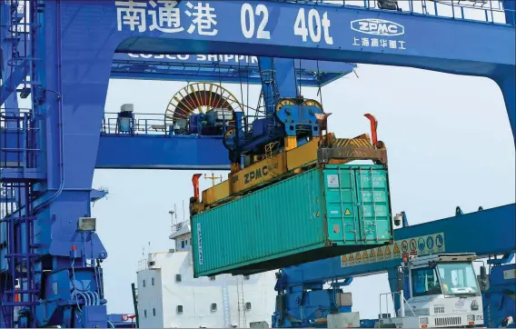  ?? XU CONGJUN / FOR CHINA DAILY ?? A gantry crane handles an export goods container at the Nantong Tonghai port, Jiangsu province, on March 22.