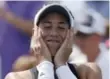  ?? JOHN MINCHILLO/THE ASSOCIATED PRESS ?? Garbine Muguruza reacts after defeating Simona Halep at the Western & Southern Open.