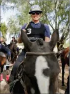  ??  ?? Jon MacLeod, from Seattle, Washington, gets on a polo pony at La Carona club, Capilla del Senor, Buenos Aires province, Argentina. “Kids start riding horses at a very early age and they get to know polo. That’s a huge advantage over other countries,”...