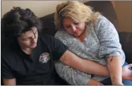  ?? CEDAR ATTANASIO—ASSOCIATED PRESS ?? Javin Lujan Lopez, 17, a senior at Pojoaque High School, and his mother, Tracy Lujan, show tattoos that they got together, at their home, in Espanola, N.M., Feb, 22, 2021. Tracy Lujan was diagnosed with COVID-19 last fall.