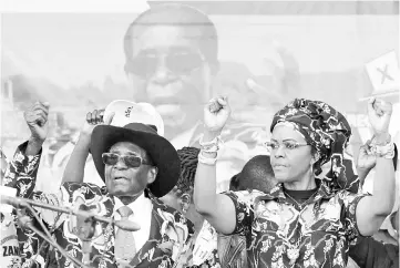  ??  ?? Mugabe and Grace attend a rally of his ruling ZANU (PF) in Chinhoyi, Zimbabwe. — Reuters photo