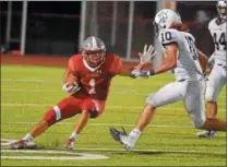  ?? PETE BANNAN-DIGITAL FIRST MEDIA ?? West Chester East wide receiver John Wileczek tries to avoid Pottstown’s Nehemiah Figueroa in the third quarter.