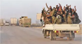  ??  ?? DEIR EZZOR: Syrian pro-government forces flash the sign for victory in the back of vehicle on the outskirts of the eastern city of Deir Ezzor, as they continue to press forward with Russian air cover in the offensive against Islamic State group...