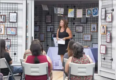  ?? CATHIE COWARD, THE HAMILTON SPECTATOR ?? Julia Jamieson speaks about “Sexual Assault: The Road Show” to people at the Ganohkwasr­a Family Assault Support Service. The travelling art show enlists communitie­s to speak out against sexual assault through artistic mediums, such as painting, drawing...