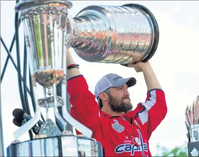  ?? AP PHOTO ?? Washington Capitals left wing Alex Ovechkin, from Russia, holds up the Stanley Cup during a victory parade and rally held at The National Mall Tuesday in Washington.