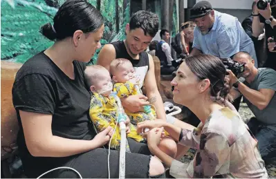  ?? PHOTO: GETTY IMAGES ?? Critical care . . . Michaela Beach holds her 7monthold twin baby Sarge BeachMoeke together with her partner Vincent Moeke holding Bycie, while they talk with Prime Minister Jacinda Ardern at Starship Hospital yesterday. Starship Hospital’s Paediatric Intensive Care Unit bed expansion project will receive $25 million in Crown funding and is one of the first infrastruc­ture projects to be funded in the NZ Upgrade Programme.