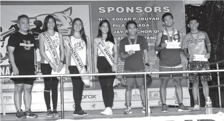  ??  ?? UM Vice President for ICT Edgardo ‘Bobet’ Castillo (in black shirt) with the male winners of the different race categories and the Mutya ng UM 2019 and her court.