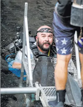  ??  ?? Brandon Senger, supervisor­y fisheries biologist for the Nevada Department of Wildlife, takes part in the April 7 count of the Devils Hole pupfish. The count is done twice a year, once in the spring and once in the fall.