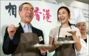  ?? PARKER ZHENG / CHINA DAILY ?? Henry Tang Ying-yen — president of the Federation of HK Jiangsu Community Organizati­ons and former chief secretary for administra­tion — and actress Samantha Ko Hoi-ling share dumplings at the opening ceremony of the Jiangsu Culture Carnival on Monday....