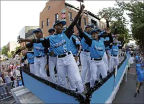  ?? GENE J. PUSKAR ?? The Caribbean Region Champion Little League team from Willemstad, Curacao, rides in the Little League Grand Slam Parade in downtown Williamspo­rt, Pa., Wednesday, Aug. 14, 2019.