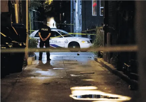  ?? COLE BURSTON / AFP / GETTY IMAGES ?? A Toronto police officer early Monday at the scene of Sunday evening’s shootings. Toronto police said Wednesday they have no evidence to substantia­te a claim by the Islamic State group that the gunman was acting for it.