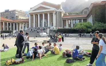  ?? /Sunday Times ?? Higher education: Students relax at the University of Cape Town campus. A probe was launched by the Department of Higher Education to determine the extent of misreprese­ntation and fraud in connection with financial aid for students.