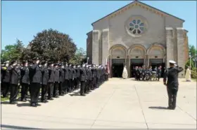  ?? KRISTI GARABRANDT — THE NEWS-HERALD ?? Beachwood and Willowick firefighte­r, Captain Michael Palumbo Jr.’s casket is carried from the church with his family following behind while fellow firefighte­rs salute.