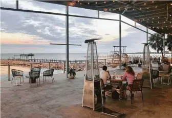  ?? Photos by Alison Cook / Staff ?? The deck at Pier 6 Seafood & Oyster House in San Leon offers a serene view over guests’ meals.