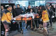  ?? CANSU ALKAYA / AP ?? Rescue and medics carry a wounded person after bomb attacks that authoritie­s said targeted police near a soccer stadium in Istanbul late on Saturday.