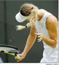  ?? AP/BEN CURTIS ?? Caroline Wozniacki of Denmark shakes her head to avoid flying insects during her 6-4, 1-6, 7-5 loss to Ekaterina Makarova of Russia on Wednesday at Wimbledon.