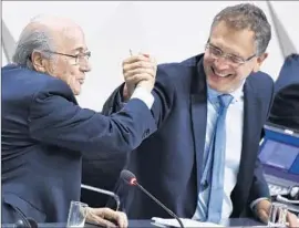  ?? Michael Buholzer
AFP/Getty Images ?? FIFA PRESIDENT Sepp Blatter, left, and his top aide Jerome Valcke, the group’s secretary general, lock hands in May; both are deeply implicated in investigat­ion.