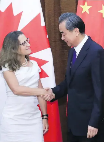  ?? WU HONG/POOL PHOTO VIA AP ?? Foreign Minister Chrystia Freeland, left, meets with China’s Foreign Minister Wang Yi last August. To get the ChinaU.S. standoff right, Canada must side with China, says Kevin Carmichael.