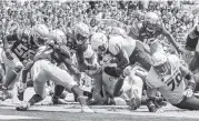  ?? MARK WALLHEISER AP ?? Boise ‘s Robert Mahone dives for the end zone against Florida State, which had a disappoint­ing day on defense. Belt).