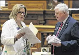  ?? BOB ANDRES / AJC ?? Sen. Renee Unterman confers with Sen. Jack Hill on the floor of the Senate. She is promoting a bill that would allow Georgia restaurant­s to serve morning cocktails on Sundays, calling it her “mimosa mandate.” Unterman’s bill would allow restaurant­s to...