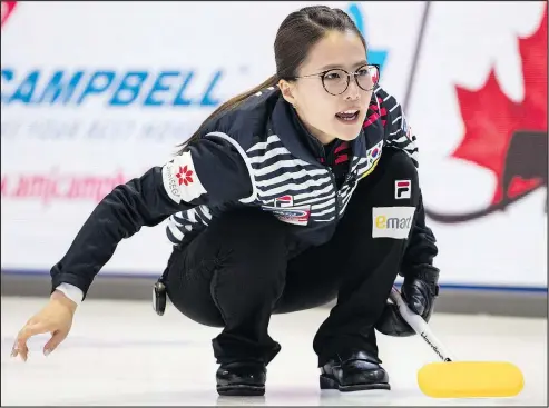  ?? PAUL CHIASSON/THE CANADIAN PRESS ?? South Korea skip Kim Eunjung directs the seep as they face Germany during the World Women’s Curling Championsh­ip in North Bay,