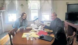  ?? COURTESY MARY GENOVA / FOR THE SUN ?? Megan Barnes, left, and the Rev. Jeremy St. Martin discussing the design of a mural they painted at St. Joseph's Catholic Church in Pepperell.