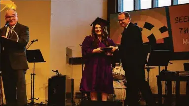  ?? Torrington Academy / Contribute­d photo ?? Torrington Christian Academy held its graduation ceremonies June 3 at the school in Torrington. Pictured, Valedictor­ian Hannah Joy Hausman receives her diploma.