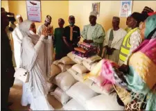  ??  ?? Dr. Bara’u and other members of the foundation during the distributi­on of food items to orphanage Homes in Funtua.