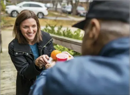  ?? MEALS ON WHEELS AMERICA VIA AP ?? Meals on Wheels America volunteer delivers a meal to homebound senior in Takoma Park, M.D. From ride-sharing apps to grocery deliveries, digital door locks to “smart” medicine dispensers, more help than ever is out there to help people live safely and...