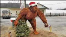  ??  ?? A 1,000-pound steel sculpture of Bigfoot stands watch over Route 4 outside a business in Whitehall.