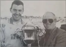  ??  ?? Eamon Franey collects the Premier trophy from Harry Griffiths.