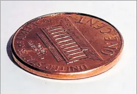  ?? LOS ANGELES TIMES / BIONAUT LABS ?? The helical Bionaut drug-delivery device, next to a penny for scale.