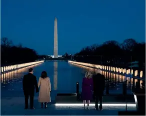  ??  ?? President Joe Biden, First Lady Jill Biden, and Vice-President Kamala Harris and husband Doug Emhoff, during Tuesday’s Covid-19 memorial at the Lincoln Memorial Reflecting Pool in Washington.AP