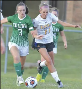  ?? Staff photo/Jake Dowling ?? St. Marys’ Krista Ruppert (11) battles with Celina’s Nicole Fennig in the first half of Tuesday’s girls soccer match.