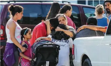  ?? John Spink / Atlanta Journal-Constituti­on via AP ?? Neighbors stand outside near a home where four children and their father were found apparently stabbed to death Thursday in Loganville, Ga., east of Atlanta. A fifth child was hospitaliz­ed with serious injuries.