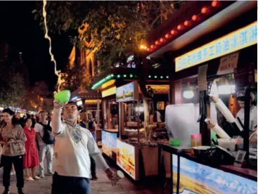  ?? ?? Snack stalls at a night market in Kashgar Old City, Xinjiang Uygur Autonomous Region, on September 4, 2023