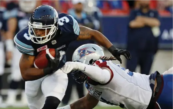  ?? MARK BLINCH/REUTERS ?? Argonauts running back Brandon Whitaker, shaking a tackle by Alan-Michael Cash of the Alouettes, gave the offence some balance with 67 yards on 15 carries at BMO Field.